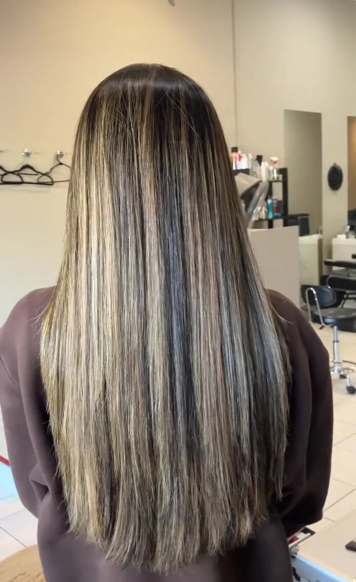 Long, sleek, smooth hair with soft blonde pieces after Nanoplasty